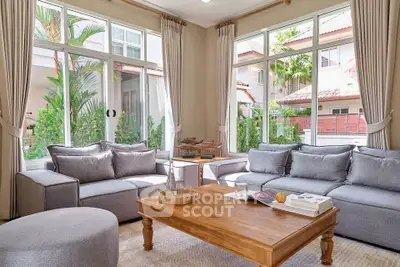 Spacious living room with large windows and modern furniture in a bright, airy home.