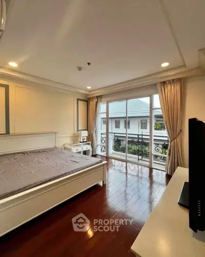 Spacious bedroom with elegant balcony view and natural light