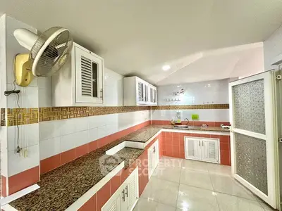 Spacious kitchen with granite countertops and ample storage in modern home