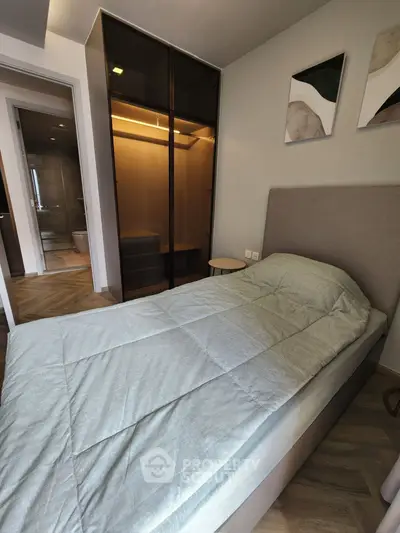 Modern bedroom with sleek wardrobe and stylish decor, perfect for urban living.