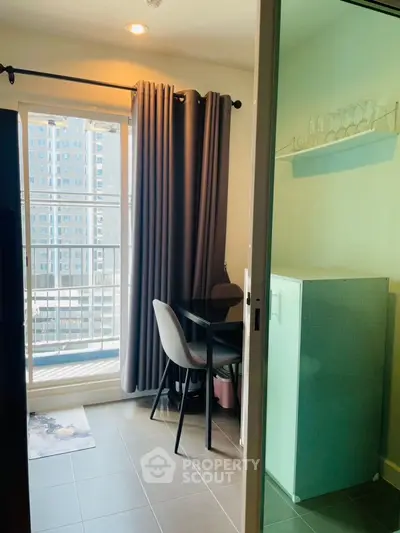 Cozy dining nook with city view, modern furnishings, and natural light in urban apartment.