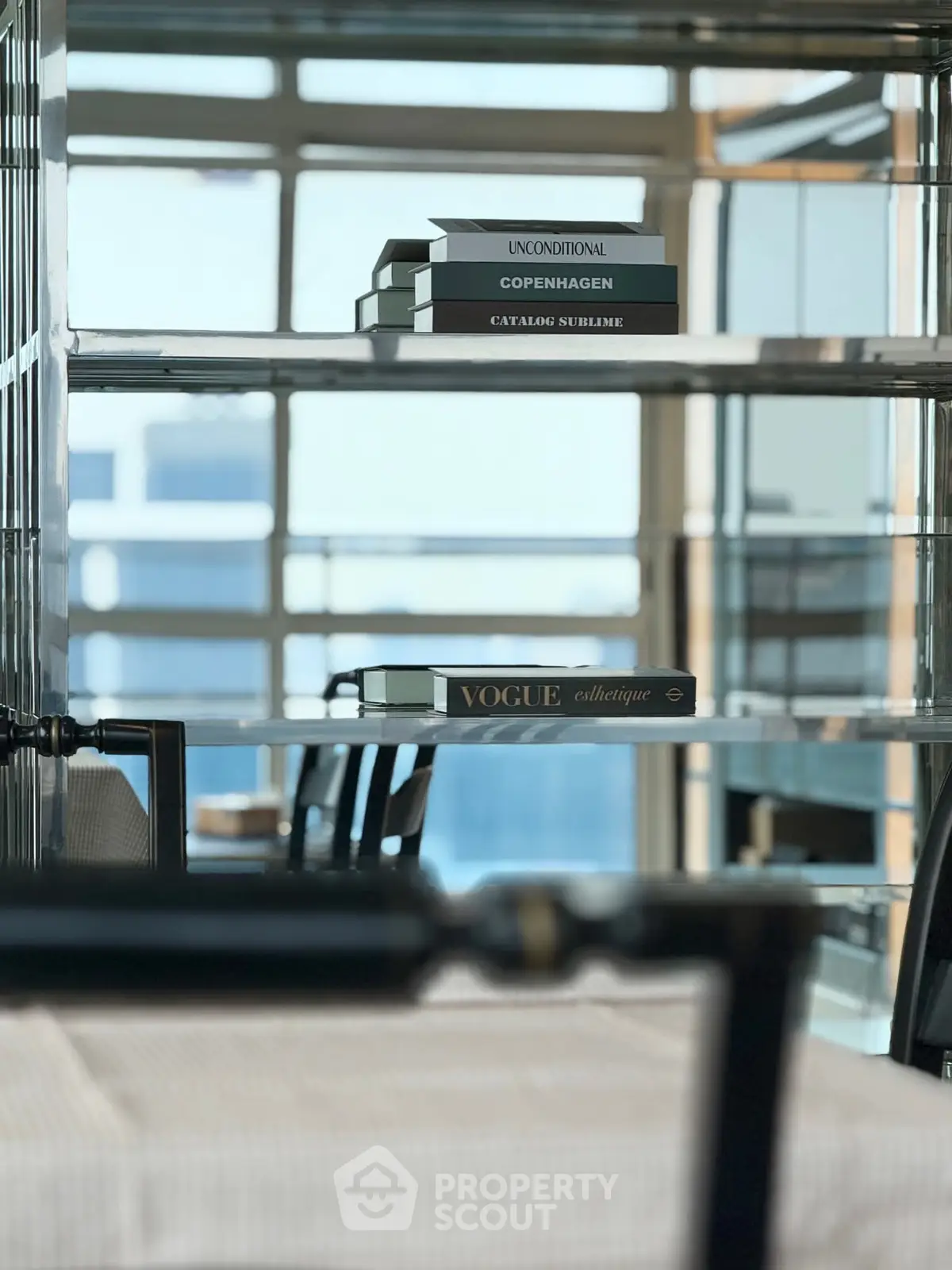 Stylish modern interior with sleek shelving and decorative books in a contemporary setting.