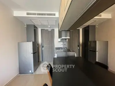 Modern kitchen with sleek appliances and open layout in a stylish apartment.