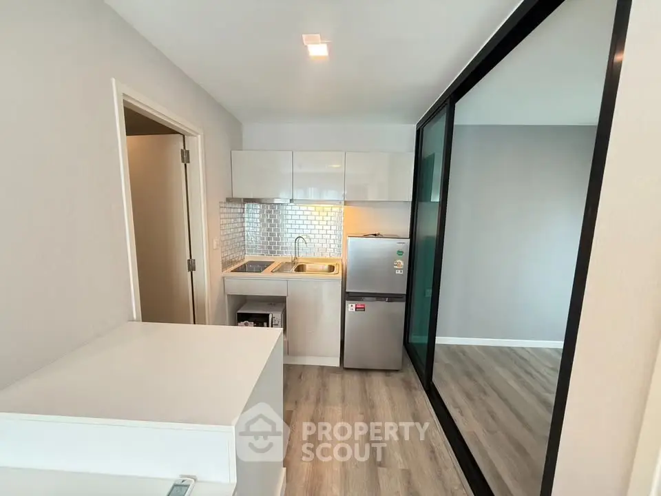 Modern compact kitchen with sleek design and stainless steel appliances