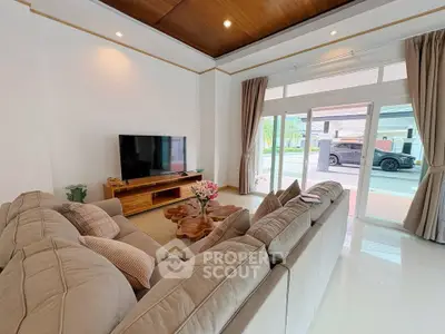 Spacious living room with modern decor and large windows offering natural light.