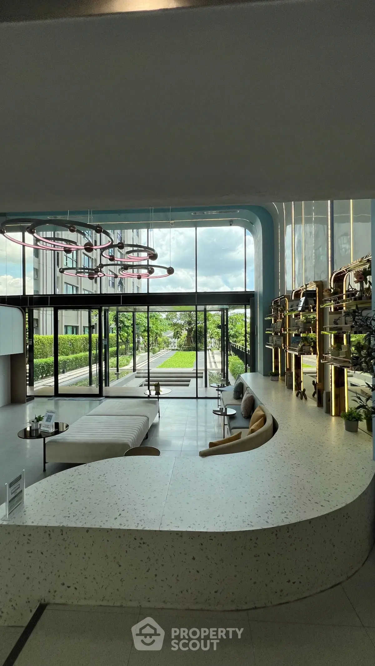 Luxurious modern lobby with stylish seating and large windows offering a garden view.