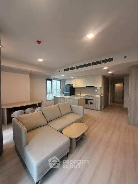 Spacious modern living room with open kitchen layout and stylish furniture