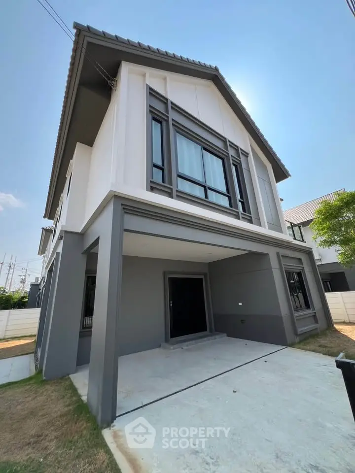 Modern two-story house with sleek design and spacious driveway