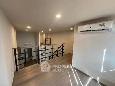 Modern loft apartment with sleek design and air conditioning, featuring open layout and stylish railing.
