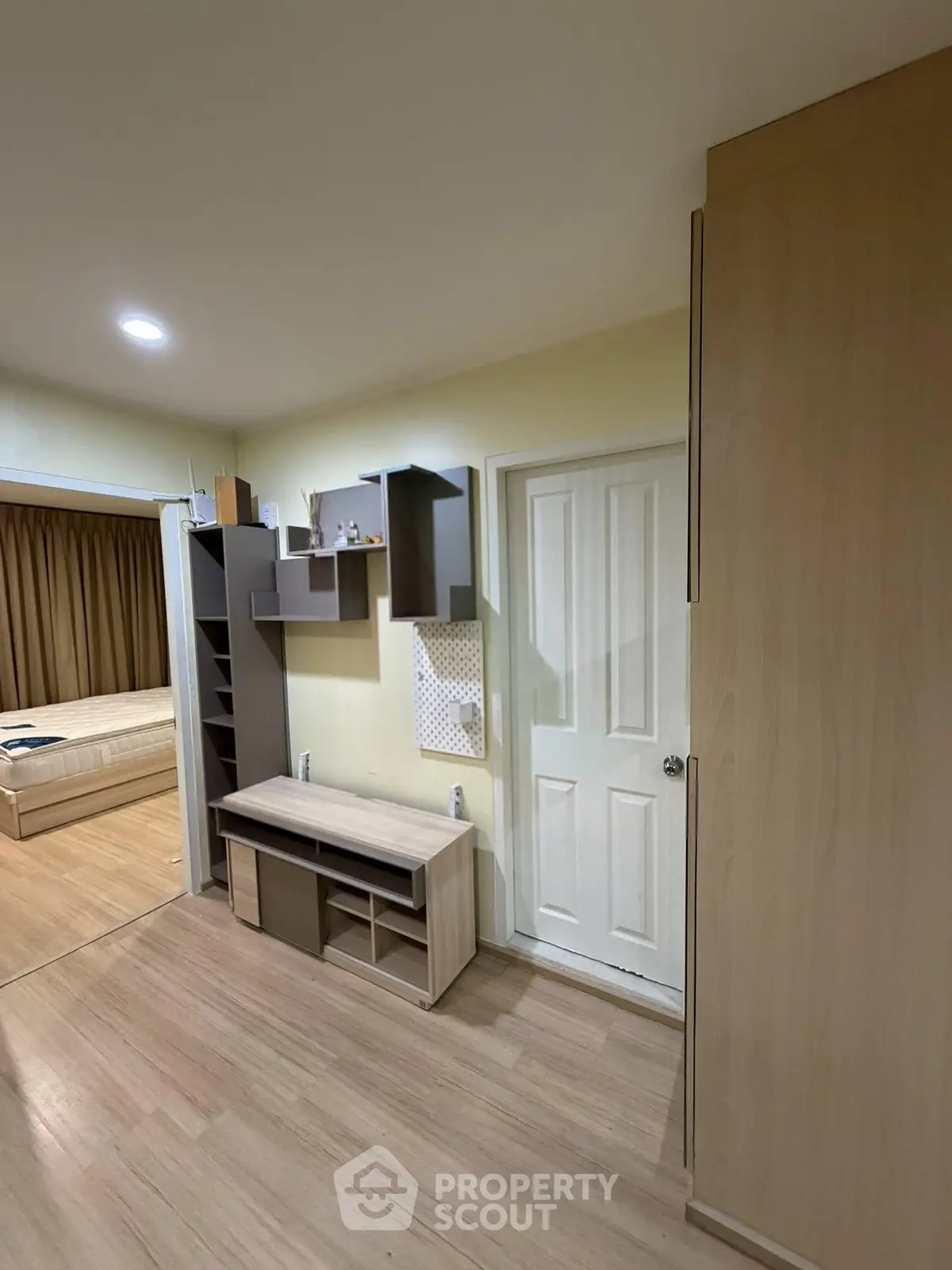Modern bedroom with wooden flooring and built-in storage solutions