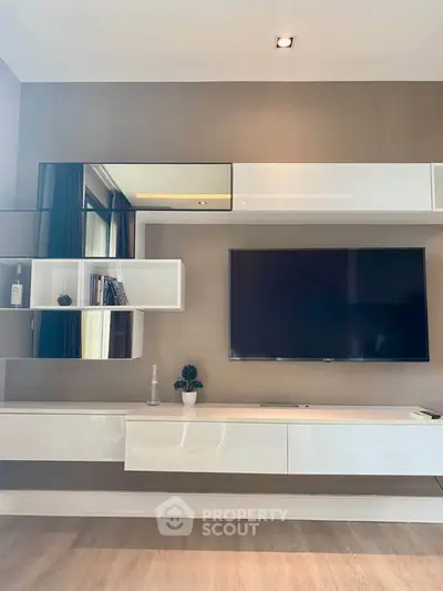 Modern living room with sleek wall-mounted TV and stylish shelving unit