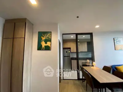 Modern open-plan living and dining area with stylish kitchen and artwork.