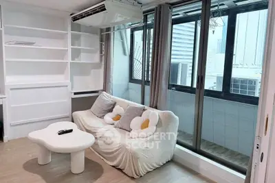 Chic living room with cozy sofa and city view balcony in modern apartment