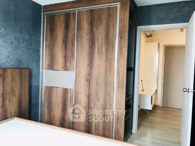 Modern bedroom with sleek wooden wardrobe and minimalist design