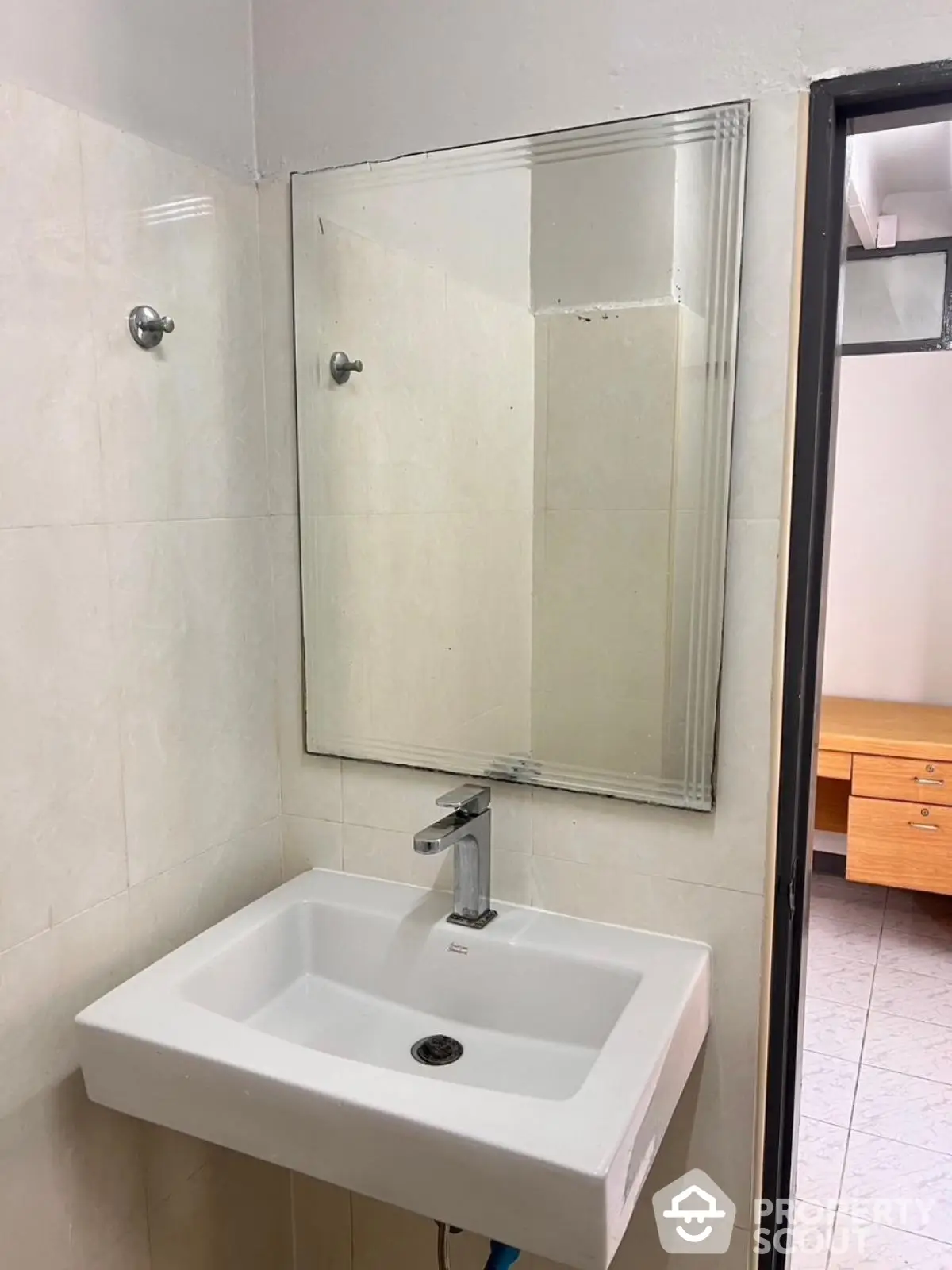 Compact bathroom with modern sink and mirror, ideal for minimalist design enthusiasts.