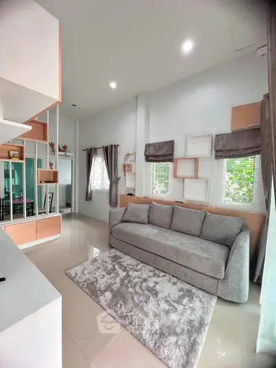 Modern living room with stylish decor and large windows for natural light