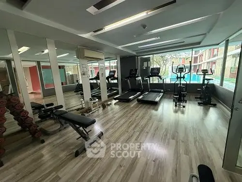 Modern gym with state-of-the-art equipment and pool view