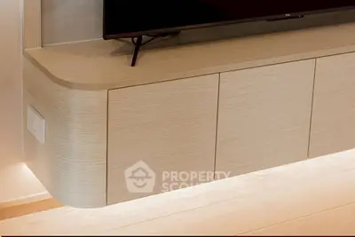 Modern wall-mounted TV unit with sleek wooden design and ambient lighting