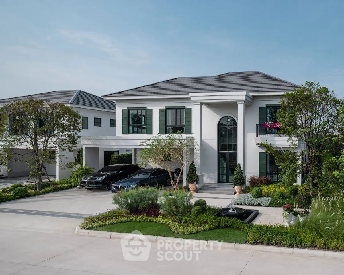 Luxurious modern mansion with manicured garden and sleek driveway, showcasing elegant architecture and spacious design.