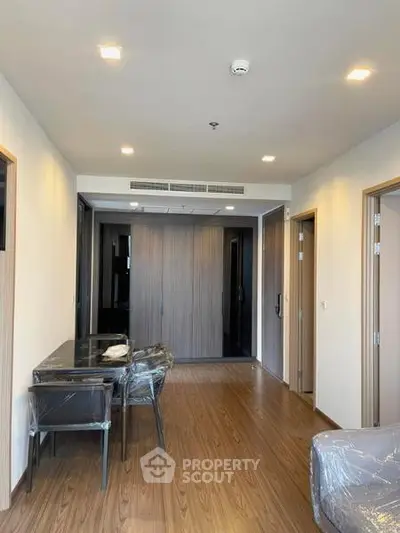 Modern apartment interior with wooden flooring and sleek furniture, showcasing a stylish and functional living space.