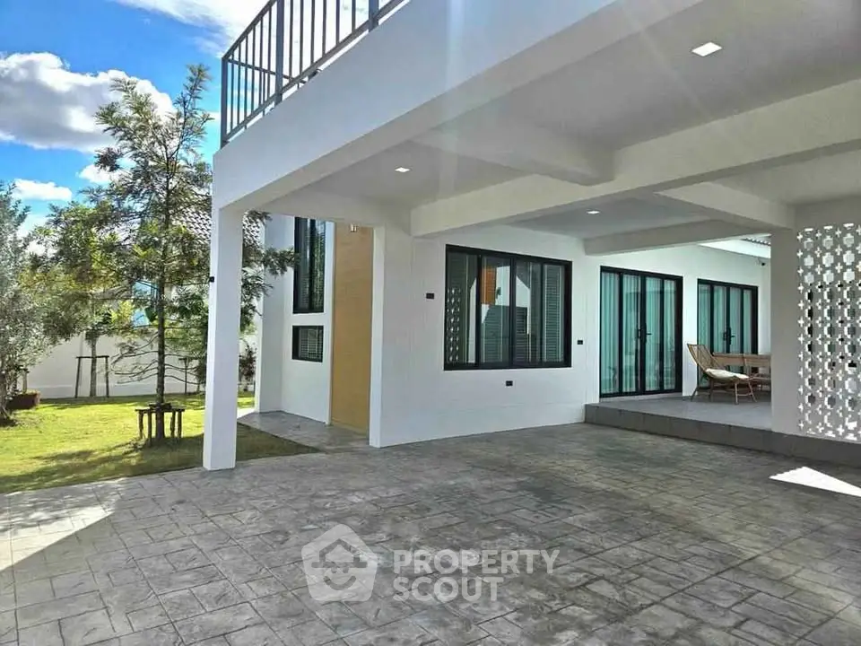 Modern home exterior with spacious patio and lush garden