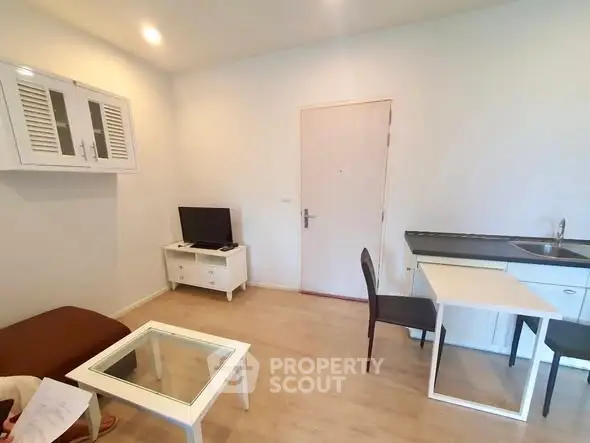 Cozy living room with modern furniture and compact kitchen area