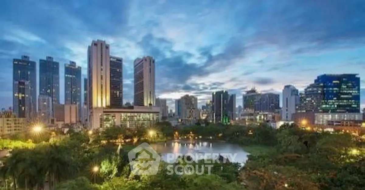 Stunning cityscape view with lush greenery and modern skyscrapers at dusk.