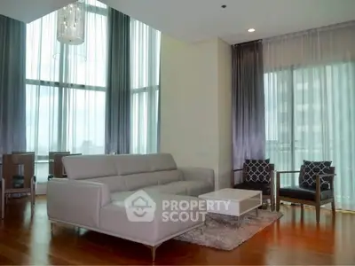 Luxurious living room with high ceilings and elegant furniture in a modern apartment.