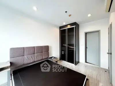 Modern bedroom with sleek black wardrobe and minimalist design