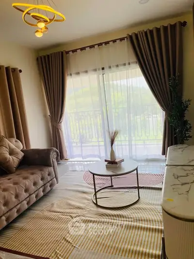 Elegant living room with plush sofa, stylish coffee table, and large window offering natural light and scenic view.