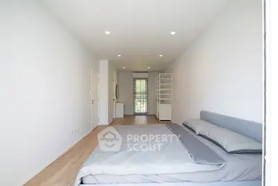 Spacious minimalist bedroom with modern decor and natural light