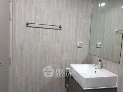 Modern bathroom with sleek sink and large mirror