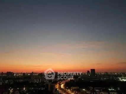 Stunning cityscape view at dusk with vibrant skyline and illuminated streets.