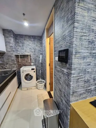 Modern kitchen with washing machine and sleek design