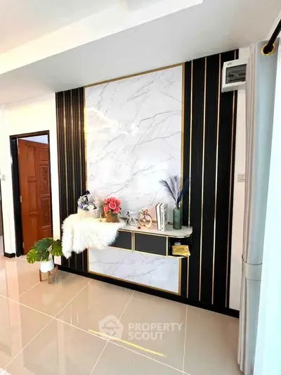 Elegant living room with marble accent wall and modern decor