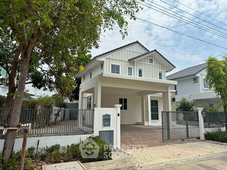 Charming two-story house with spacious driveway and lush greenery in a serene neighborhood.