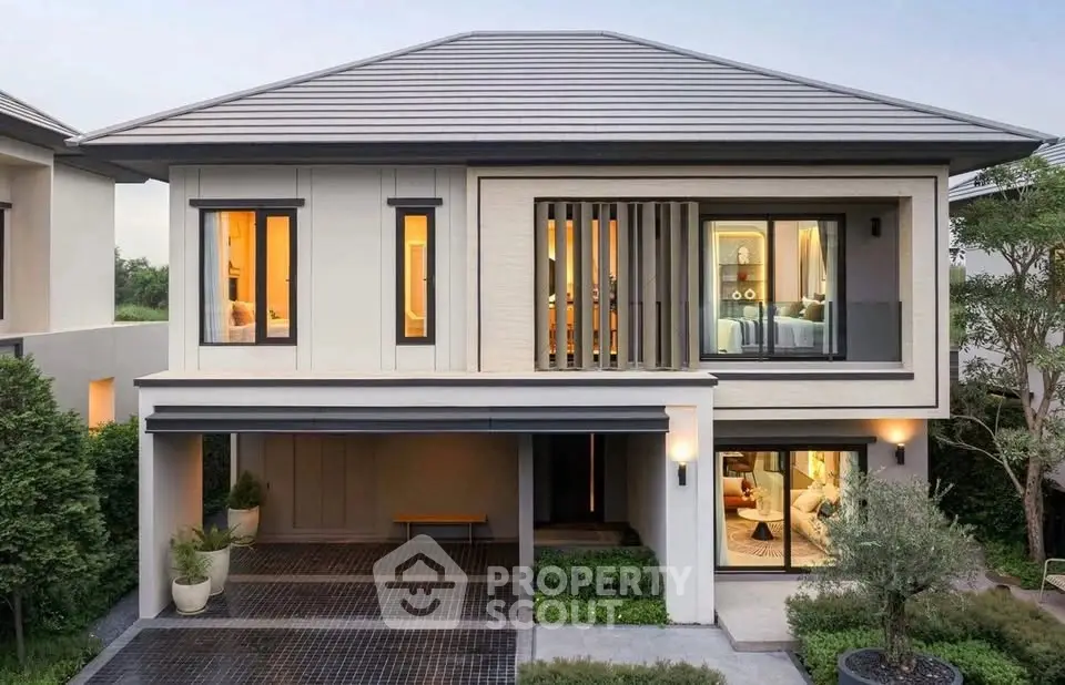Modern two-story house with sleek design and spacious driveway in a serene neighborhood.