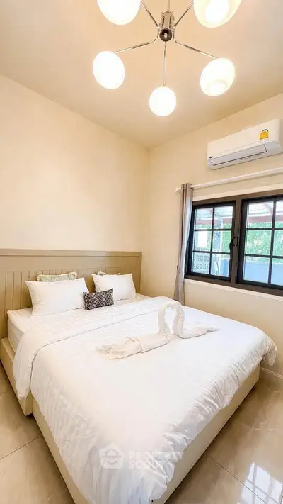 Cozy bedroom with elegant lighting and air conditioning, perfect for relaxation.