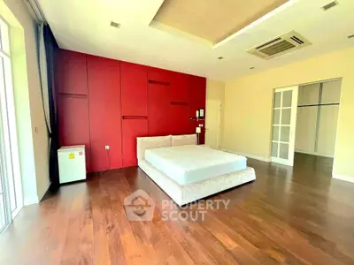 Spacious bedroom with modern design and wooden flooring