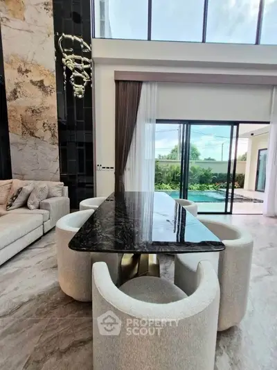 Luxurious modern living room with elegant marble dining table and pool view