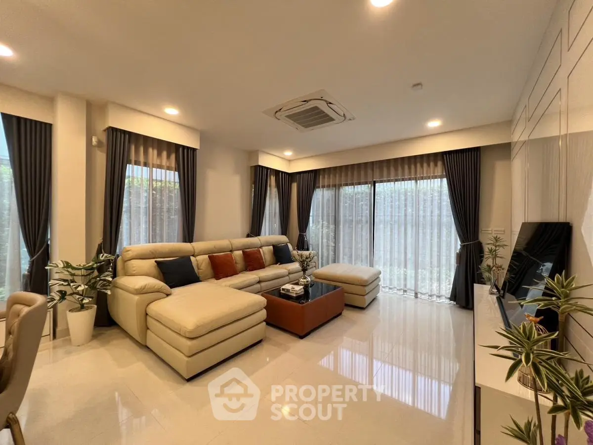 Spacious modern living room with elegant decor and large windows for natural light.
