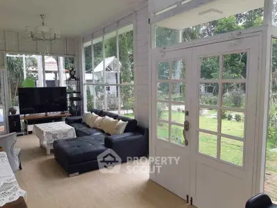 Charming sunlit living room with garden view and elegant decor