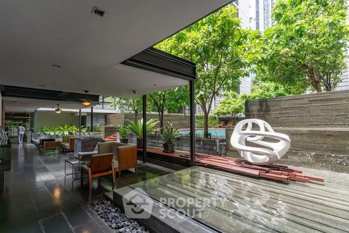 Luxurious modern outdoor area with stylish seating and lush greenery, perfect for relaxation and entertainment.