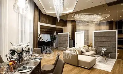 Luxurious open-plan living room with elegant decor and modern furnishings, featuring a stunning chandelier and cozy seating area.