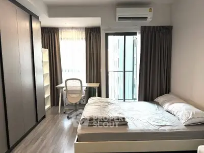 Modern bedroom with study area, featuring sleek design and natural light.