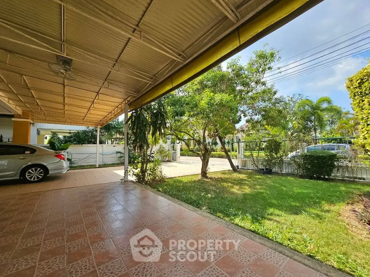 Spacious covered carport with lush garden view in suburban home