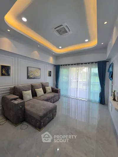 Luxurious living room with modern sofa, elegant lighting, and large windows with blue curtains.