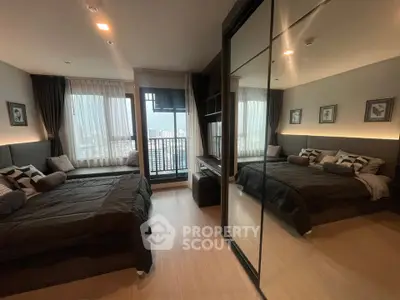 Modern bedroom with large windows and city view, featuring mirrored wardrobe and cozy decor.