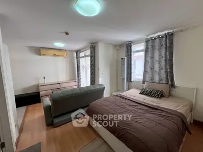 Spacious bedroom with modern decor and ample natural light