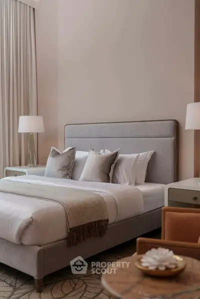 Luxurious bedroom with elegant decor and plush bedding in a modern apartment.